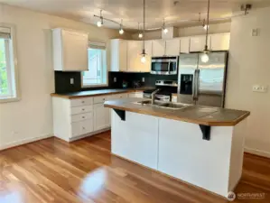 Open kitchen concept with white cabinets
