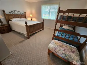 Guest bedroom sleeps several people.