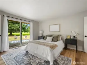 Primary bedroom with slider leading to the back patio...plenty of room for a hot tub!