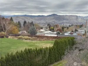 Mountain and valley views from living room during the day.