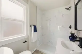 Three quarter bath off the primary is convenient and is complete with privacy glass that allows light, but privacy.