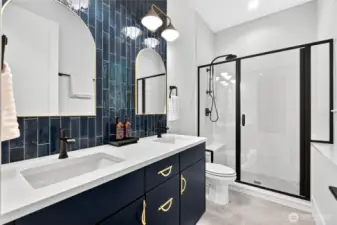 Main-level guest suite ensuite offers convenience, privacy, and luxury, featuring heated floors.