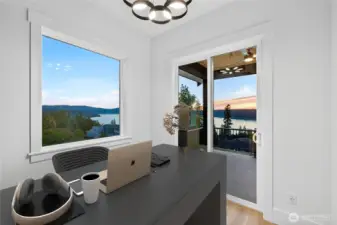 Private office/library tucked into a quiet corner of the main level, featuring breathtaking Lake Sammamish views and a dedicated sliding door to the wraparound deck.