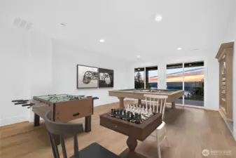 Lage rec room of kitchenet on lower level walking out to fully covered patio with breathtaking views of Lake Sammamish.