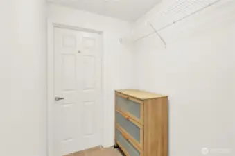 Walk-in closet leading to bathroom