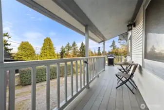 Covered composite deck with access to fenced back yard.