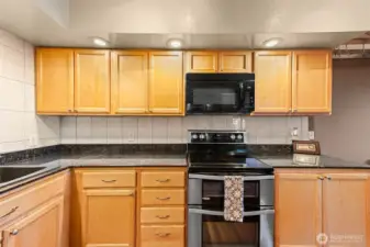 Kitchen provides generous counter sapce and storage options. Custom cabinets with lazy susans and other surprises. Top quality newer applinaces.