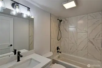 Hallway bathroom with lovely tile work and fixtures