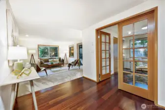 Reclaimed engineered hardwoods flow from the entry to the kitchen & dining area - and the 2nd bedroom that is setup as an office.