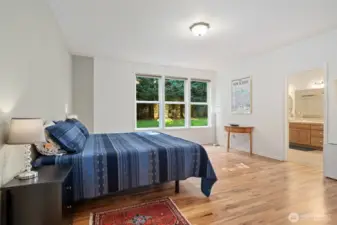 Huge Primary bedroom with ensuite bath. Look at those gorgeous wood floors!