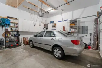 Spacious 2-car garage with lots of built-in cabinetry. Loft area provides tons of storage space.