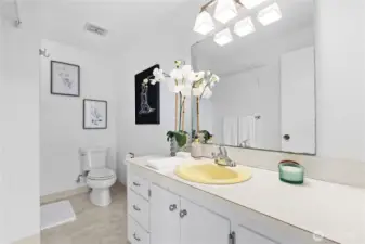 Primary bathroom with original Formica printed countertops and matching pale yellow sink