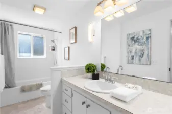 Main bathroom with double sinks, cabinets and extra storage