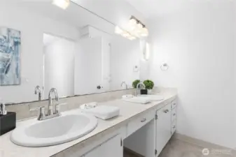 Main bathroom with double sinks, cabinets and extra storage
