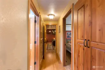 The hall features many solid wood doors, and two custom built-ins for display and storage.