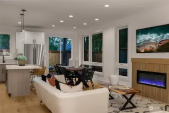 Light filled living room opens to the kitchen.