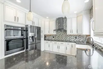 Glass tile backsplash and updated cabinetry and countertops