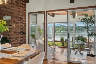 Original lakeside patio was enclosed into a wonderful, light-filled sunroom with fireplace
