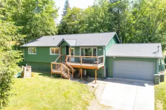 A wonderful private setting for this great home with an extra large garage. Room for parking inside plus aa additional hidden space for office/shop/storage inside garage area.  Clean exterior paint, and newer roof show the care and love this home has had by its current owners.  Front deck is a newer addition that allows basking in the sunshine on a bright morning.