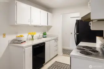The kitchen is close to the entry to the condo and is between the dining/living spaces and bathroom.