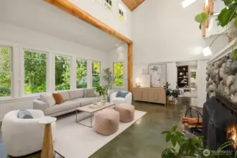 This view of the living room faces the primary suite, with the study/library seen through the open doorway.
