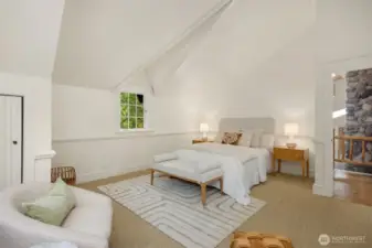 The upstairs en-suite bedroom’s dormer windows offer both a charming architectural touch and elevated views of the grounds.