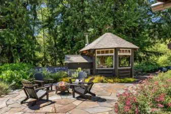 On the opposite side of the pizza gazebo lies even more gorgeous patio space for entertaining, or just for admiring the grounds. It offers views of the front yard, berry patch, chicken coop, strawberry beds, and herb gardens.