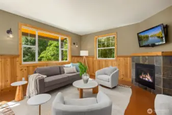The living room features a propane fireplace for ambiance and additional heat, and the floors here are sustainable and comfortable cork.