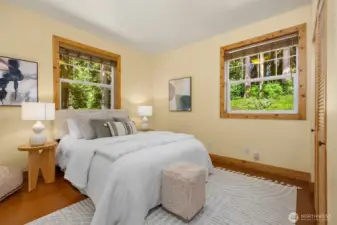 The cottage offers a single bedroom complete with a standard closet, and across the hall lies a 3/4 bath with laundry.