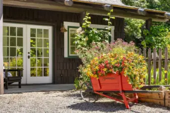 The studio space is graced by yet another covered patio, and is adjacent to a cottage-style herb and flower garden awaiting the next lucky owner’s additions where the rich soil was not planted this year.