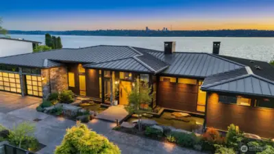 Front exterior - showing standing seam metal roof and extensive, automated soffit lighting.