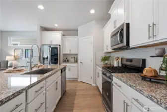 Indulge in culinary master pieces in this gourmet kitchen, thoughtfully designed to provide ample counter space, cabinetry storage and functional layout for ease of use from prepping station to the gas cooktop.