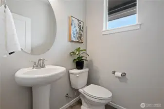 Convenient main floor powder room discreetly located right off the front entrance.