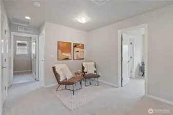 To the right of the loft area is the first bedroom and to the left of the loft area is the hallway to the other two bedrooms and utility room.