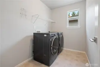 Spacious utility room with full-size Washer/Dryer set that stays.