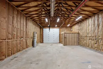 Oversized insulated garage/shop with dedicated power, and oversized door.
