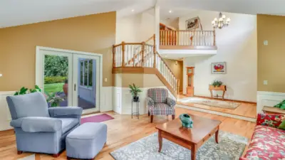 Beautiful architectural design is showcased in the formal living room with seamless flow to the outdoors and a striking staircase centerpiece.