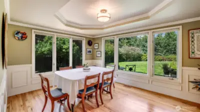 Walls of windows bring the outdoors in, creating a bright and inviting dining experience. Dine while enjoying the gorgeous, private landscape.
