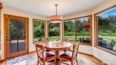 This breakfast nook offers indoor–outdoor living with direct access to the deck.