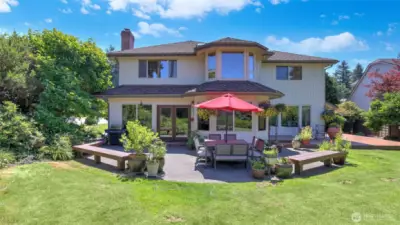 Private outdoor living space featuring a large patio and vibrant surroundings.