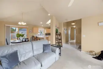 Open concept living, dining & kitchen space with a sliding glass door to the back patio.