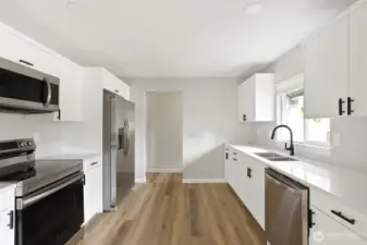 Quartz counter tops, lvp, stainless steel.