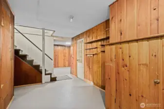 Enter to the basement where there is a large bonus room, laundry, storage and access to garage