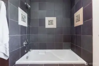 Oversized soaking tub with tiled surround