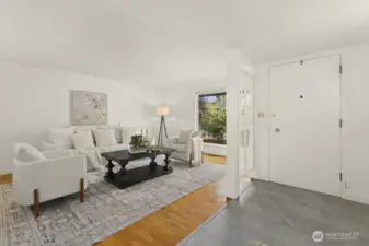 Spacious entryway opens to large living room.