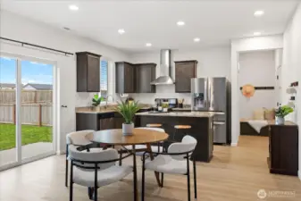 Kitchen and dining space and slider to backyard.