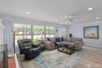 Comfortable gathering space with updated flooring and recessed lighting.