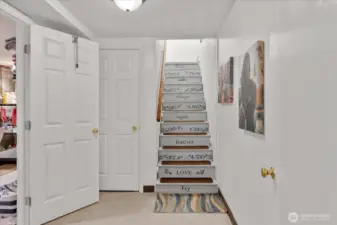 Staircase off the living room leading to the spacious lower level.