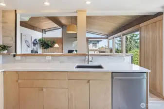 Newer cabinets, solid countertop and custom maple live-edge slab detail.