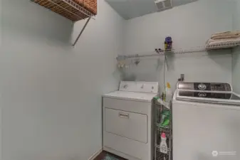 Large laundry room with shelves.